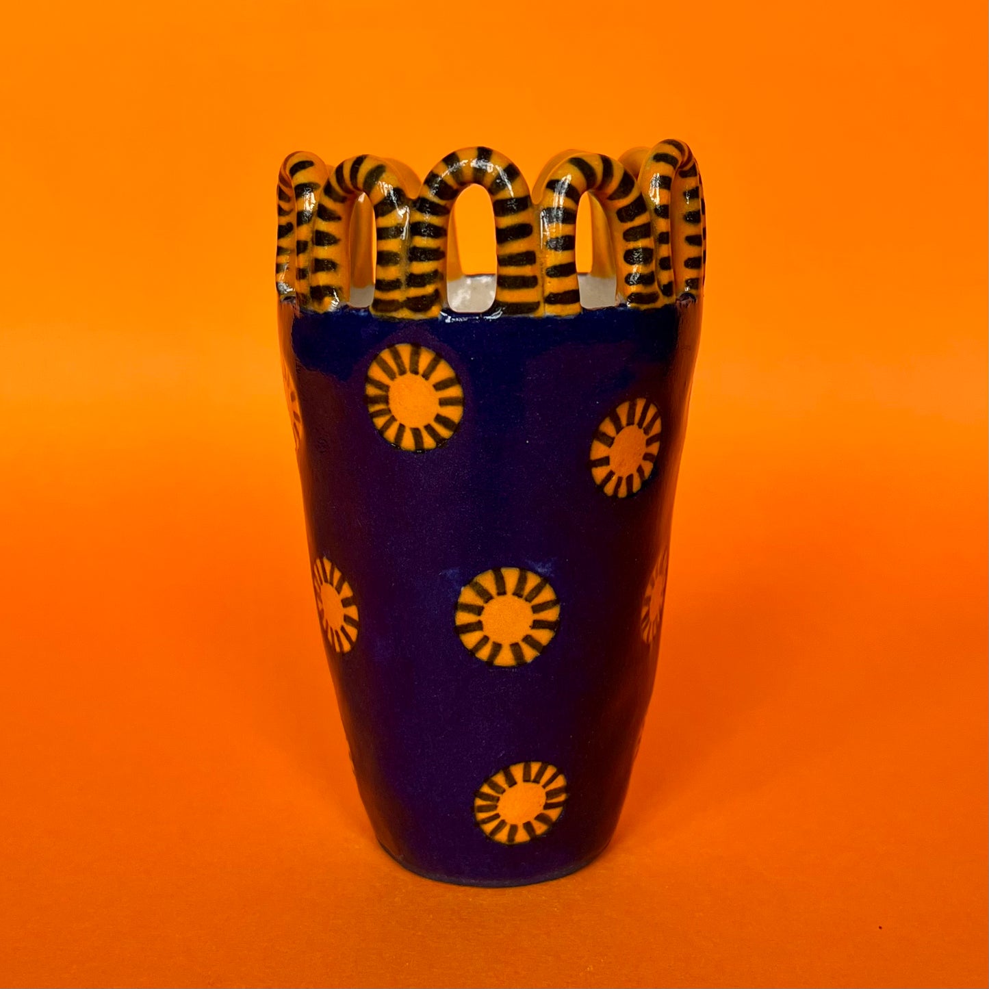 Blue with Orange Sun Circles and a Stripy Looped Crown