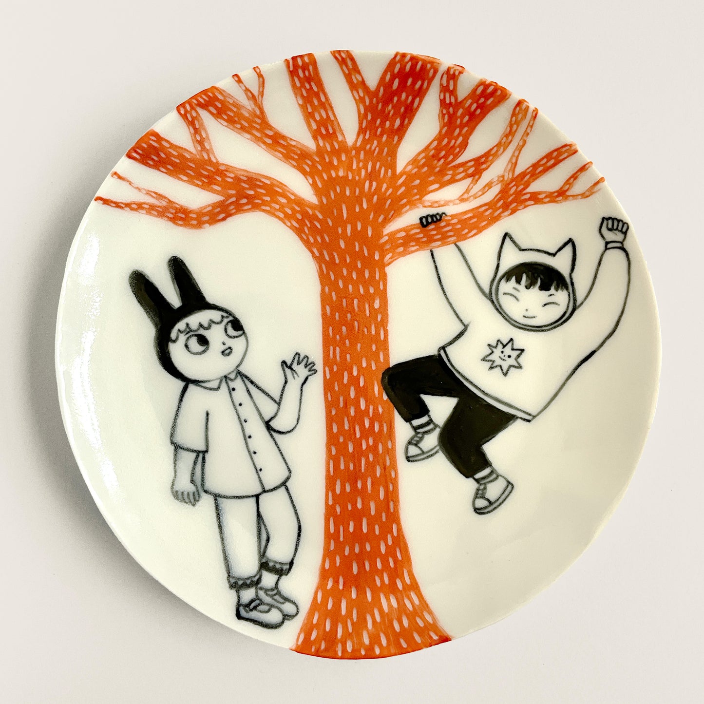 Bunny and Cat play under an Orange Tree plate