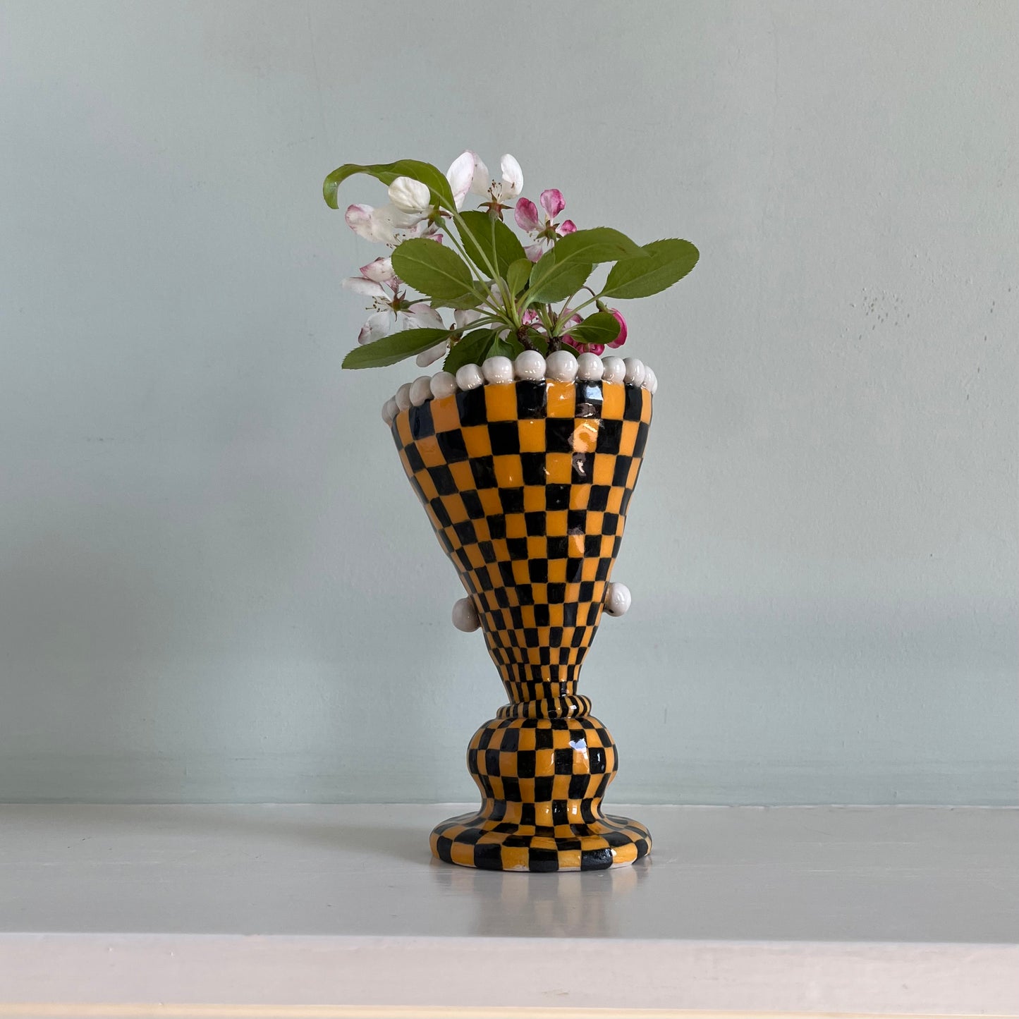Orange checkered lady with pearl earrings
