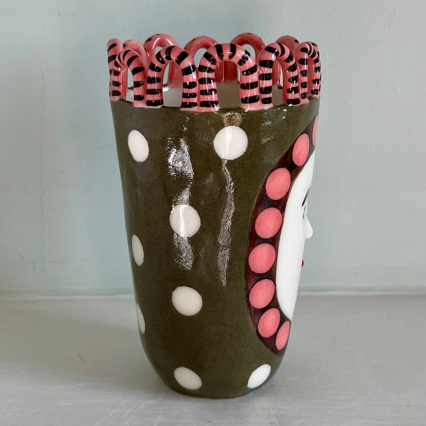 Green Man with Pink and Chocolate Brown Surround, and White Spots