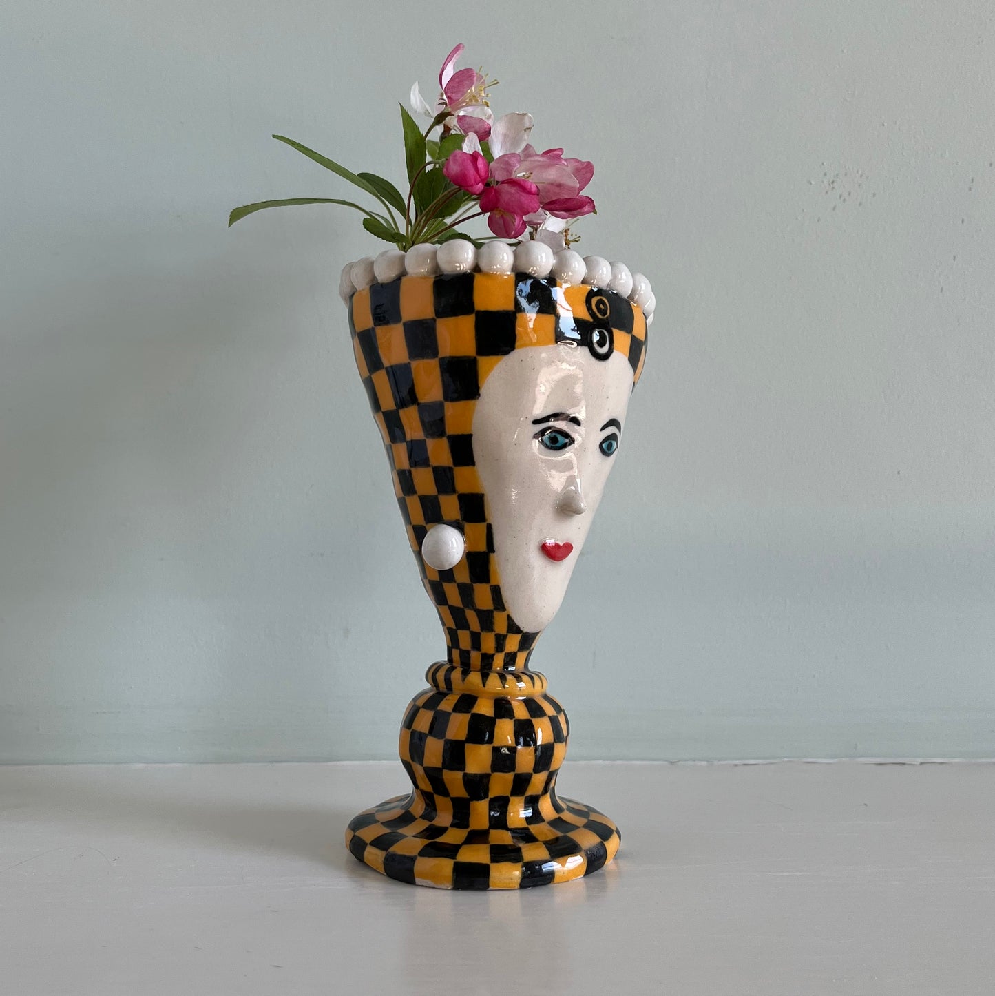 Orange checkered lady with pearl earrings