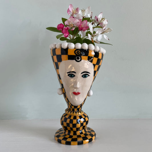 Orange checkered lady with pearl earrings